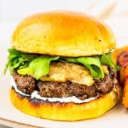 A lamb burger with caramelized onions and whipped feta sauce.