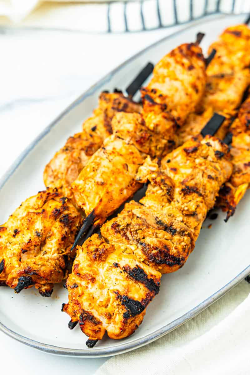 Mediterranean chicken kabobs on a platter.