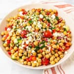 A serving bowl of Mediterranean chickpea salad.