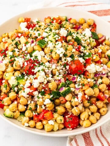 A serving bowl of Mediterranean chickpea salad.