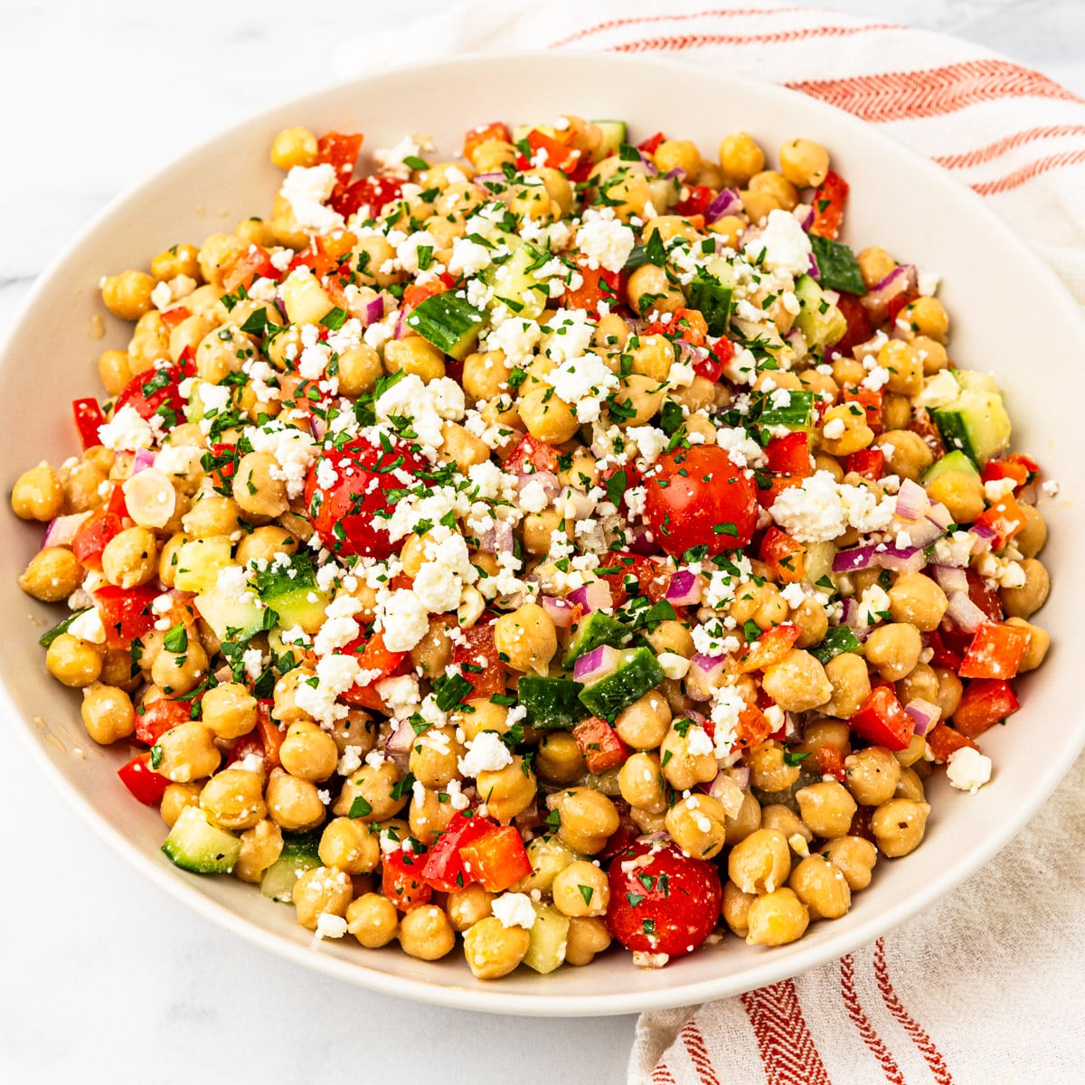 A serving bowl of Mediterranean chickpea salad.