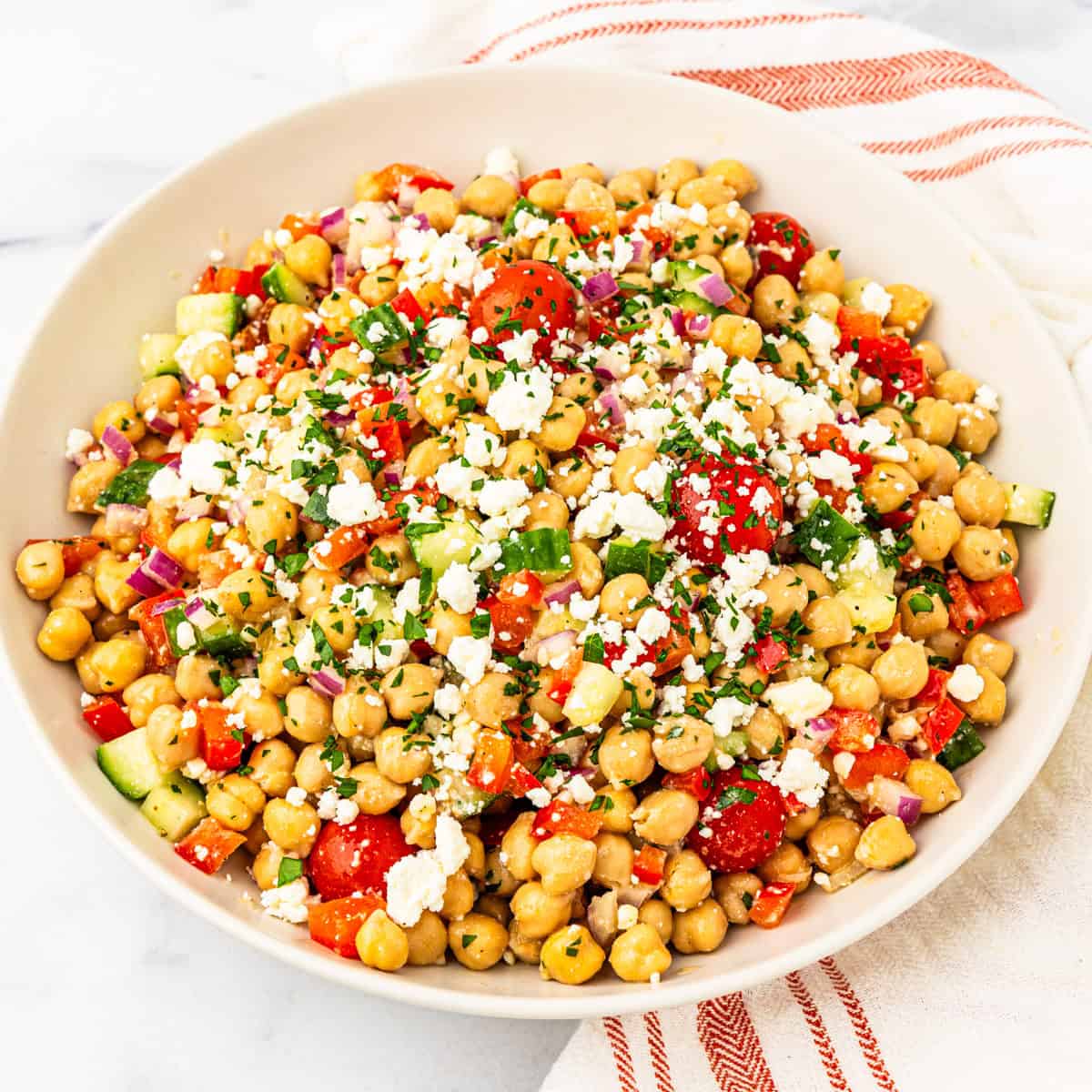 A bowl of chickpea salad tossed with lemon herb vinaigrette.