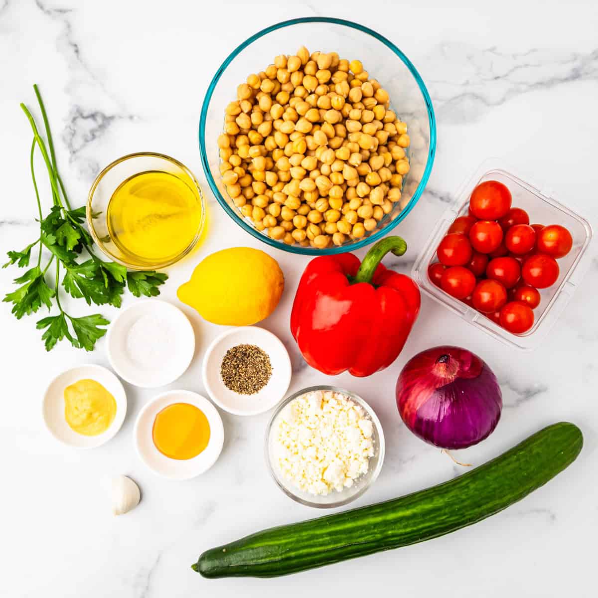 Ingredients for chickpea salad arranged on a countertop.