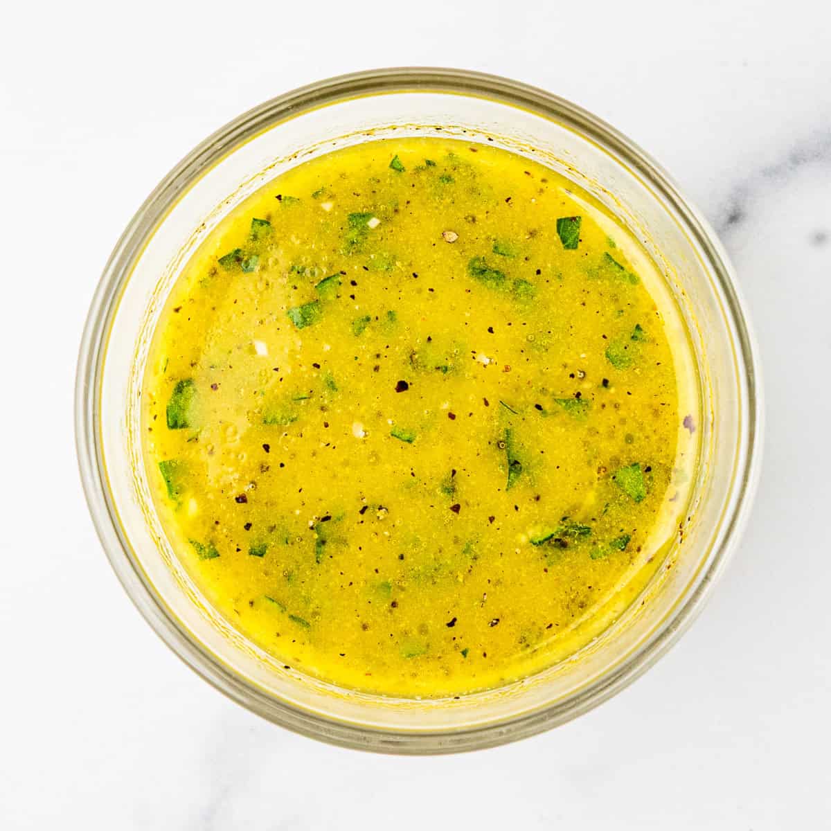 Lemon herb vinaigrette in a small bowl.