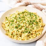 A bowl of lemon and herb couscous on a countertop.