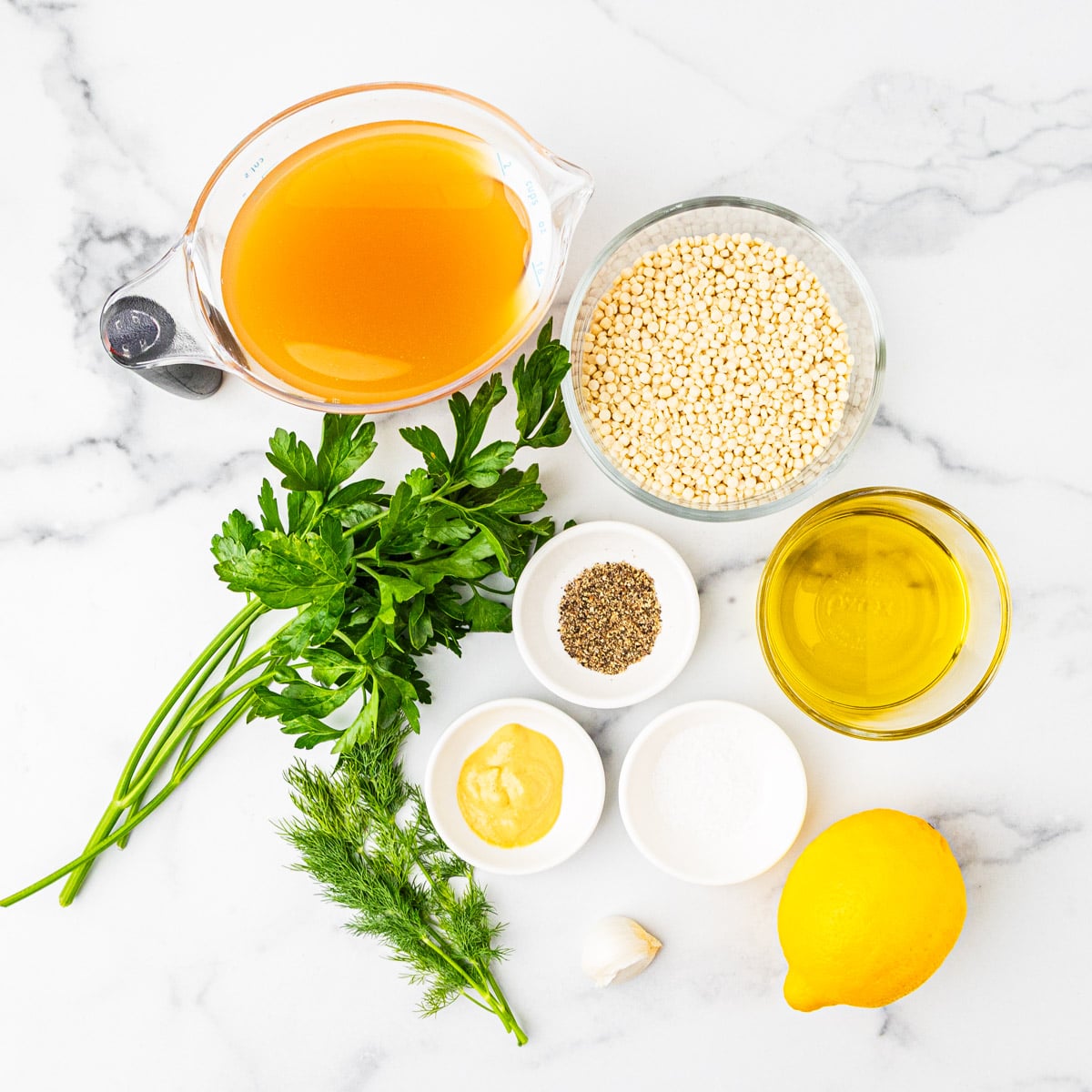 Ingredients for lemon herb couscous arranged on a countertop.