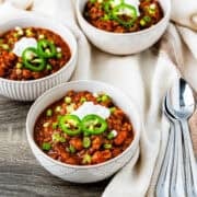 Bowls of turkey lentil chili on a table.