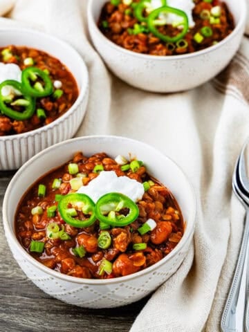 Bowls of turkey lentil chili on a table.