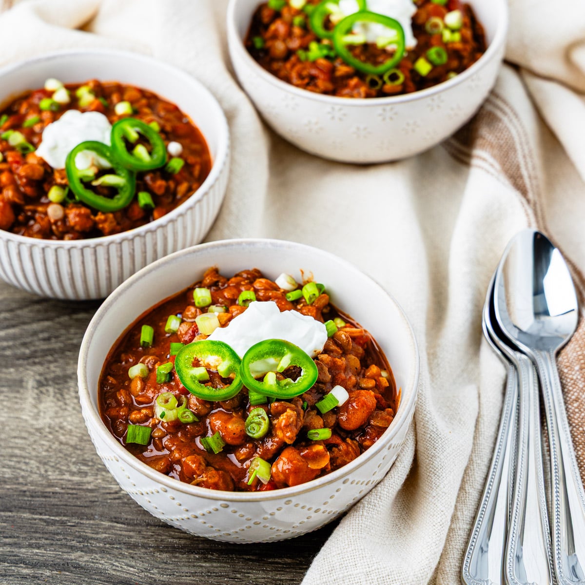 Bowls of turkey lentil chili on a table.