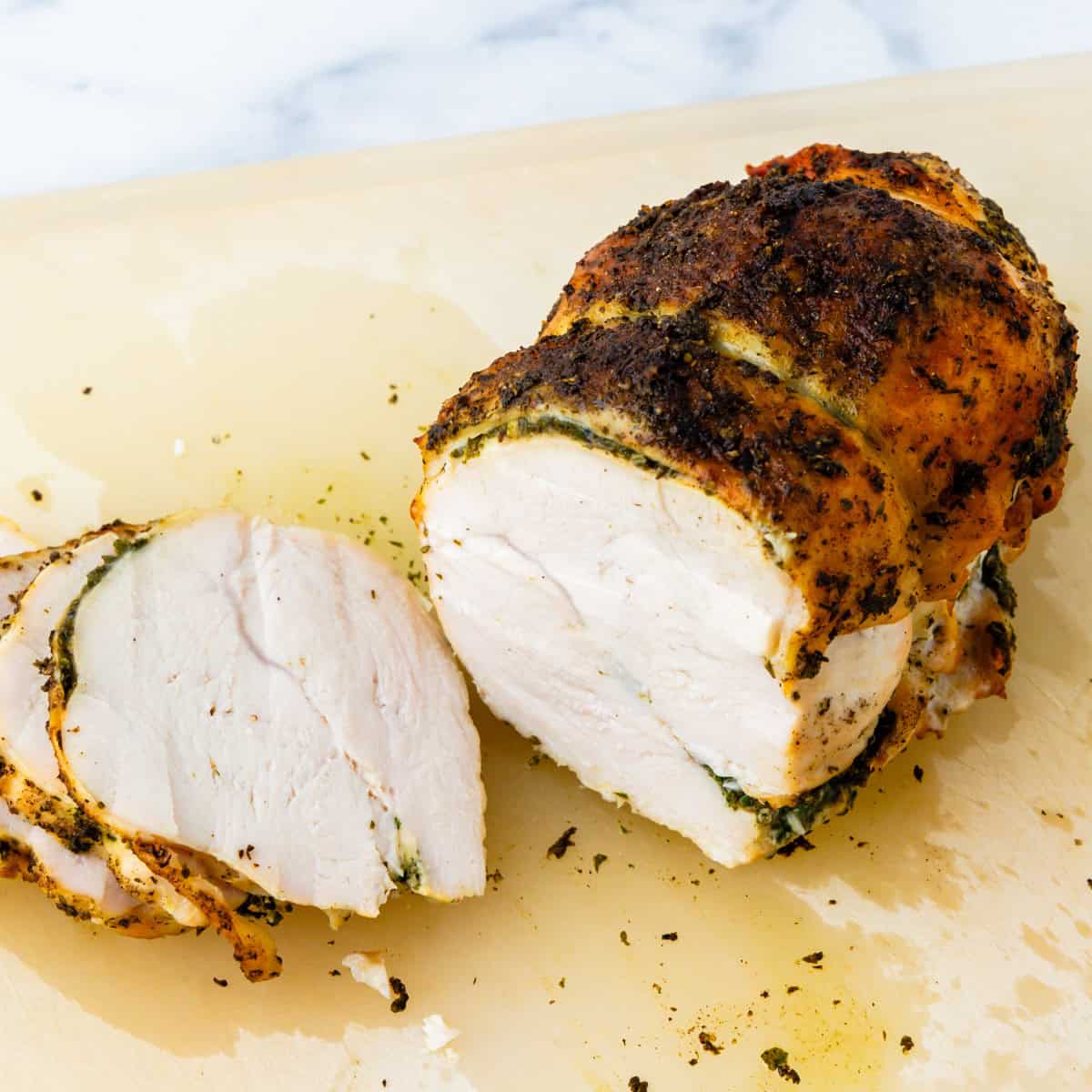 Boneless turkey breast being sliced.