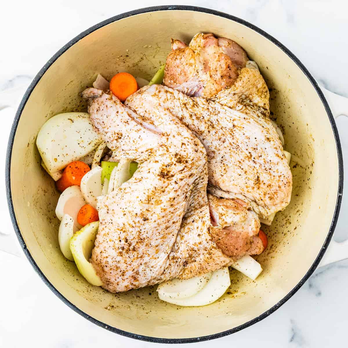 Seasoned turkey wings before being roasted.