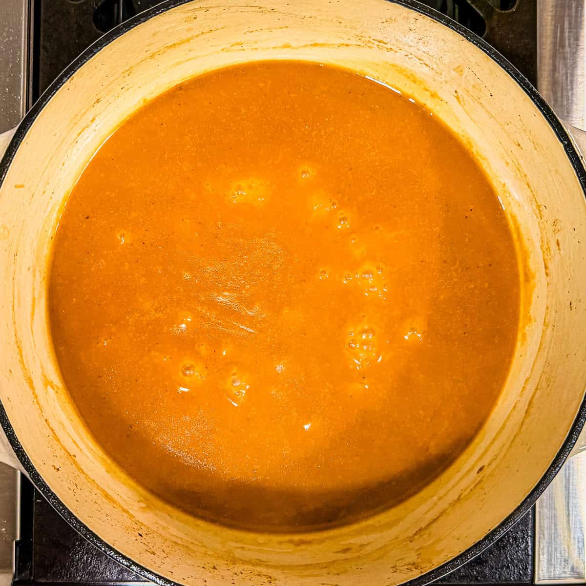 Turkey gravy simmering in a Dutch oven.